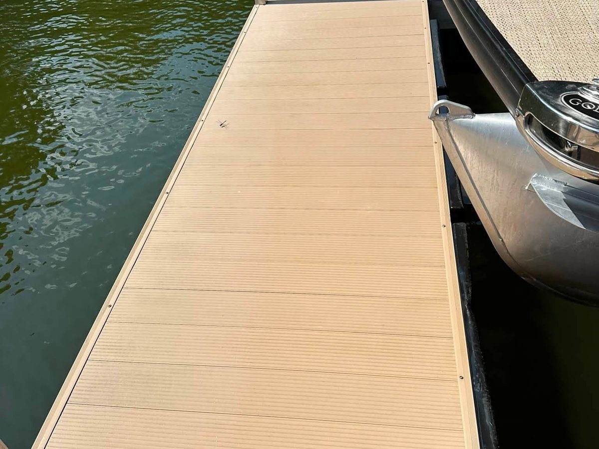 New composite decking running along a boat dock at the water