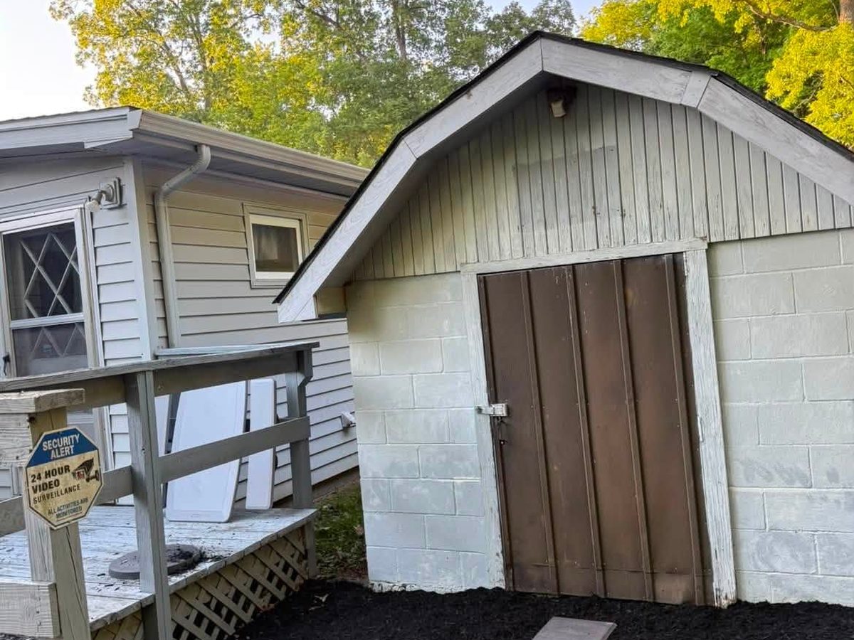 Stepping stone path set into fresh mulch leading to a garage
