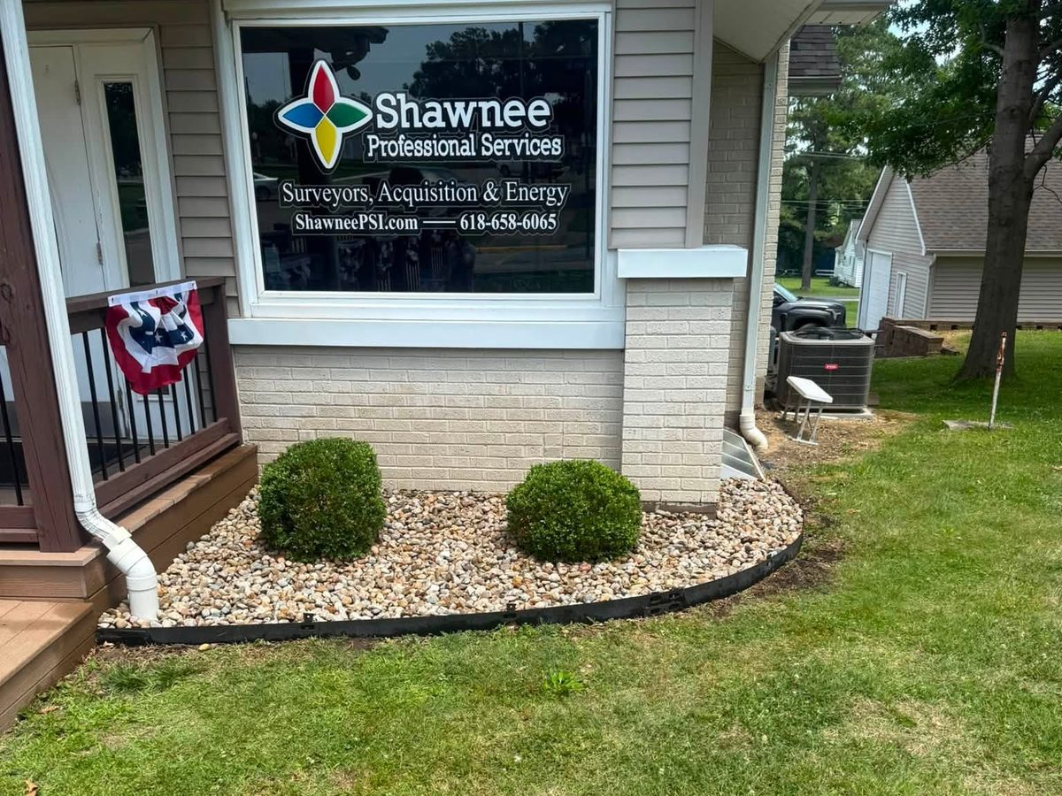 Finished rock bed and trimmed shrubs outside a local business