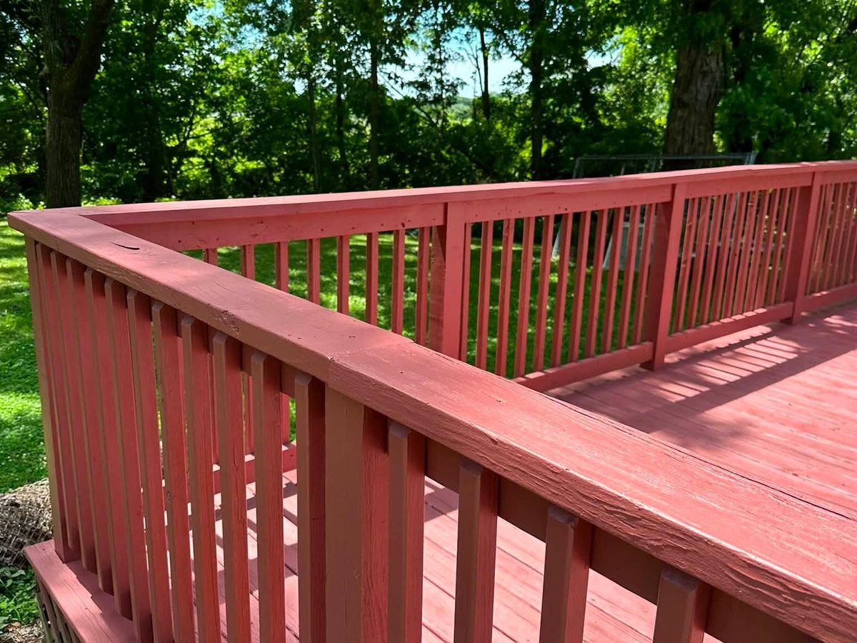 Restored deck railing and decking stained a deep red
